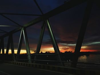 Illuminated bridge against sky at night