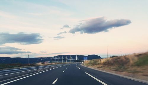 Road against millau bridge during sunset