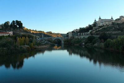 Scenic view of river against clear blue sky