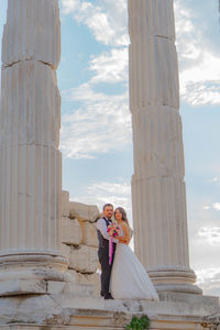 Couple kissing against built structure