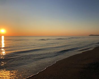 Scenic view of sea against clear sky during sunset