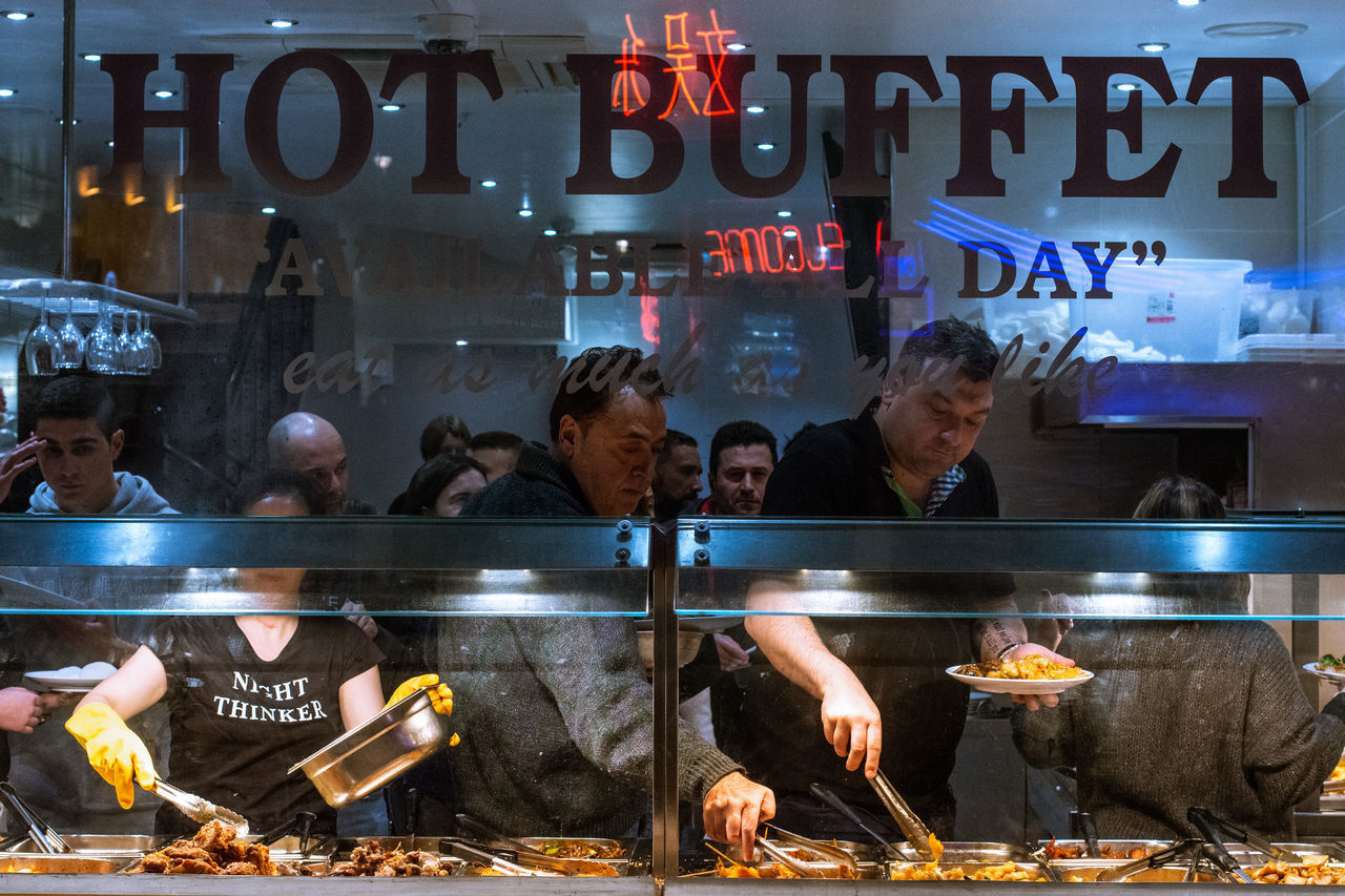 food and drink, group of people, real people, illuminated, food, communication, people, women, text, meat, men, flame, burning, heat - temperature, retail, business, adult, city, fire, crowd, outdoors