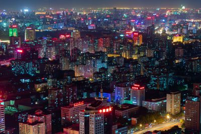 High angle view of illuminated buildings in city at night