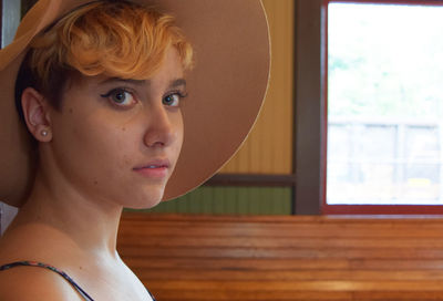 Portrait of young woman in hat