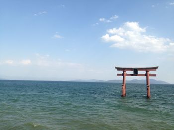 Lifeguard hut in sea against sky