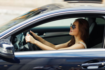 Close-up of woman sitting in car