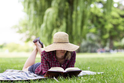 A young woman reads a book in a park in the columbia gorge.