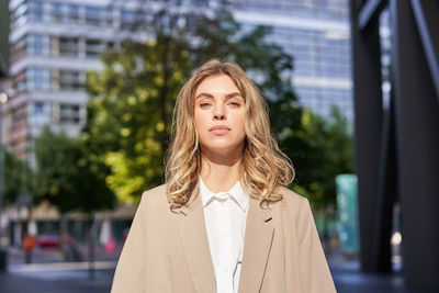 Portrait of young woman standing outdoors