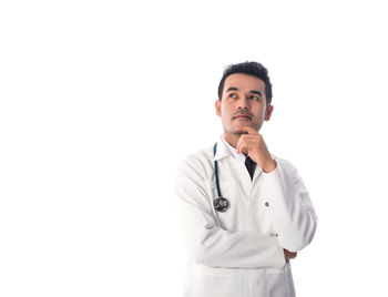 Thoughtful doctor over white background