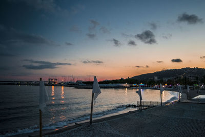 Scenic view of river against sky at sunset