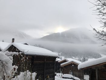 Snow covered landscape against sky