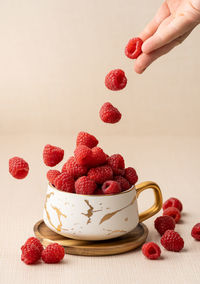 Close-up of hand holding strawberries