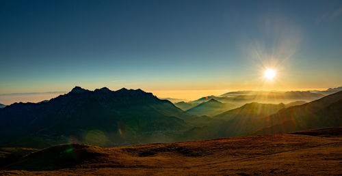 Scenic view of mountains against sky during sunset