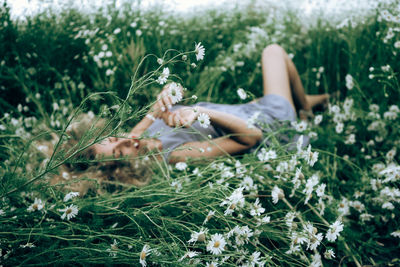 Young woman lying down on land