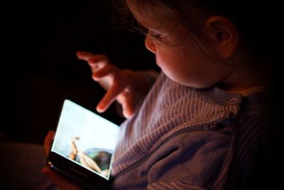 Close-up of girl using mobile phone