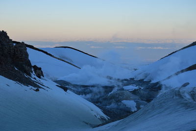 Scenic view of snow mountains against sky during sunset