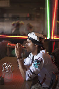 Young man drinking a soda at a restaurant