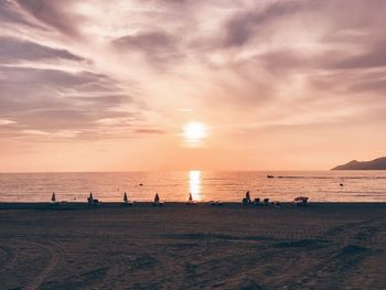 Scenic view of beach against sky during sunset