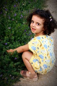 Portrait of cute girl sitting on field