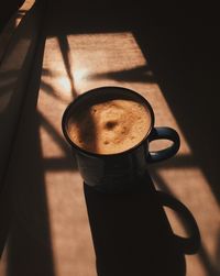 High angle view of coffee cup on table