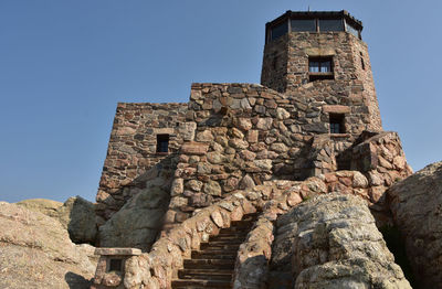 Old stone watch tower on top of harney peak in custer state park.