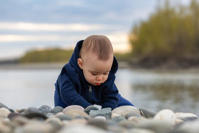 Side view of boy looking at lake