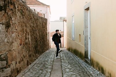 Rear view of man walking on walkway