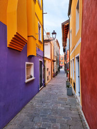 Footpath amidst buildings in city