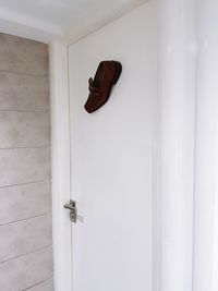 Close-up of shoes on door