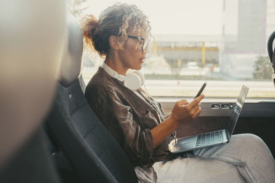 Side view of man using mobile phone