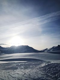 Scenic view of snow covered mountains against sky