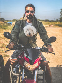 Portrait of man with dog on motorcycle 