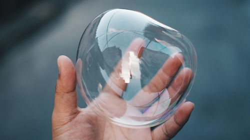 Close-up of hand holding light bulb