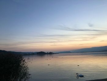 Scenic view of lake against sky during sunset