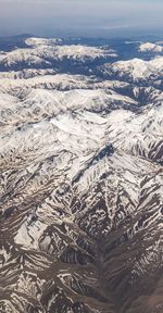 Aerial view of snowcapped mountain against sky