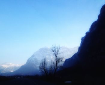 Scenic view of mountains against clear blue sky