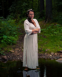 Portrait of mature woman standing in pond