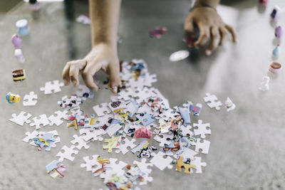 Cropped hand playing jigsaw puzzle