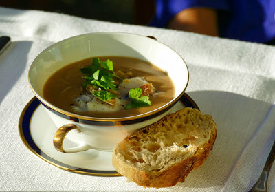 Delicicous chestnut soup with scallops and a piece of bread