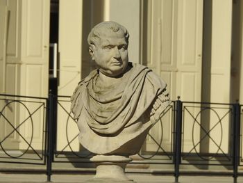 Portrait of statue against railing