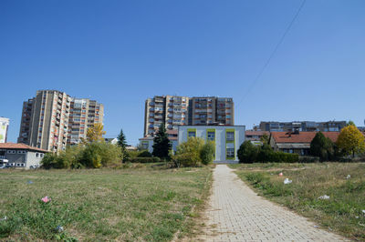 View of buildings in city against clear sky