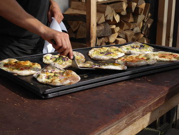 Midsection of man preparing food in restaurant