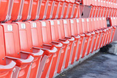 Empty orange seats at stadium,rows walkway of seat on a soccer stadium