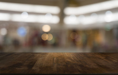 Close-up of defocused lights on wooden table