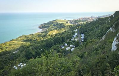 High angle view of trees and sea against sky