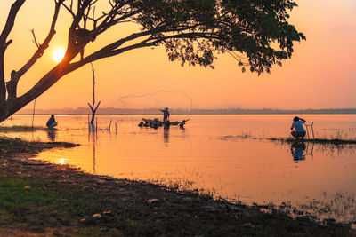 Scenic view of lake against sky during sunset
