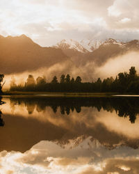 Scenic view of lake against sky during sunset