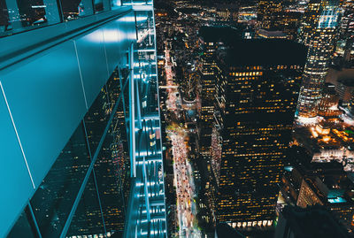 Illuminated buildings in city against sky at night