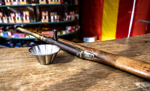 High angle view of gun by bowl on table