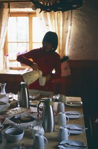 Man sitting on table in kitchen